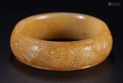 A HETIAN JADE BANGLE CARVED WITH AUSPICIOUS PATTERN