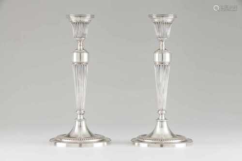 A pair of candlesticksPortuguese silverNeoclassical style decorationFluted shaft on a c