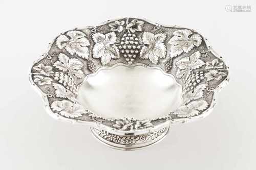 A footed fruit bowlPortuguese silverPlain base with raised wine related decoration to lip