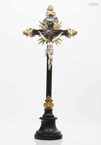 A crucified ChristIvoryCarved and gilt wooden crossSilver radiant halo and labelPor