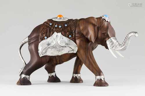 An elephantVarved wood and silverSculpture with raised and engraved silver trunk and decora