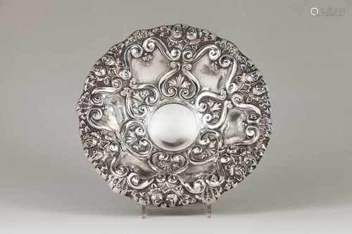 A fruit bowlPortuguese silverRepousse decoration of winglets, foliage and flowersOn a c