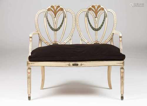 A D.Maria style setteePainted woodPierced back and caned seatPortugal, 20th century