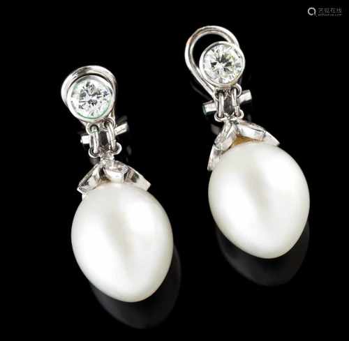 A pair of earringsPear shaped pearls crowned by floral half sphere set with 10 navette cut diam