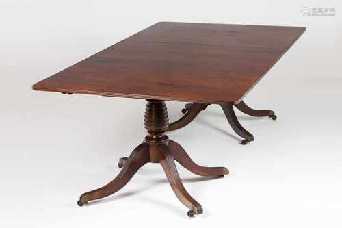 An English style dining tableMahoganyRectangular topOn two turned pedestals each of thr