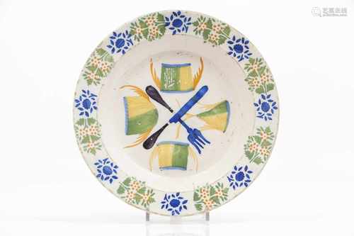 A platePortuguese faiencePolychrome decoration of cutlery and fish slicesFloral motifs