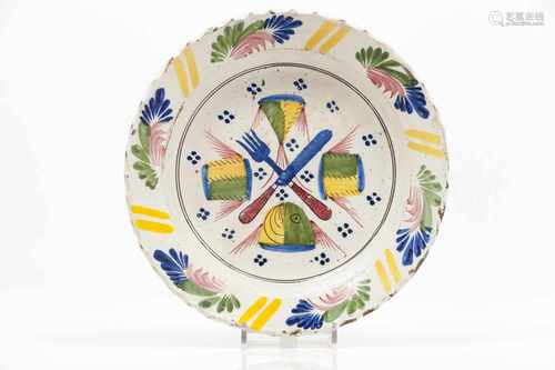 A scalloped platePortuguese faiencePolychrome decoration with cutlery and fish slicesFl