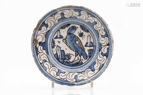 A plateFaienceCobalt blue and manganese decoration of landscape with buildings and birdsbr