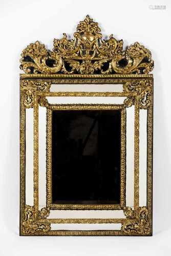 A large mirrorDeep slanted wooden frameRaised and gilt metal floral and foliage decoration