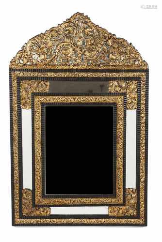 A mirrorDeep slanted wooden frameRaised and gilt metal floral and foliage decorationSca