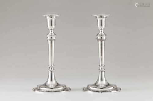 A pair of D.Maria candle standsPortuguese silverPlain shaft and stand with beaded friezesb