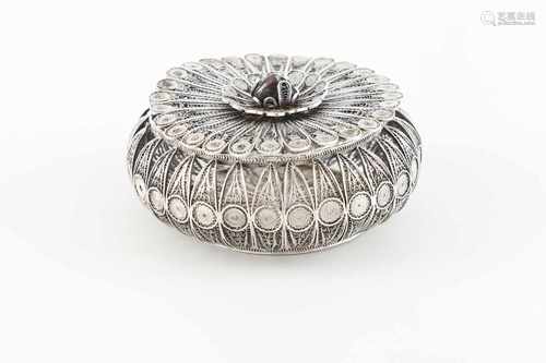 A circular boxSilver filigreePierced body with cabochon cut hardstone lid pommelUnmarke