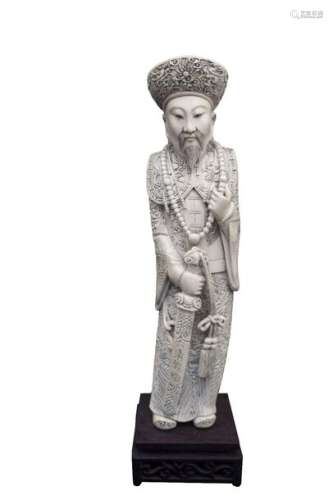 AN IVORY CARVING OF A STANDING DIGNITARY China, ea…