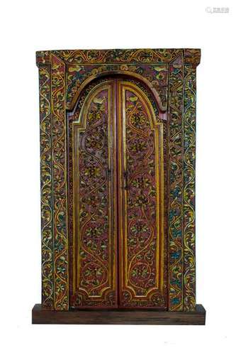 A BALINESE CARVED AND PAINTED WOOD DOOR Early 20th…