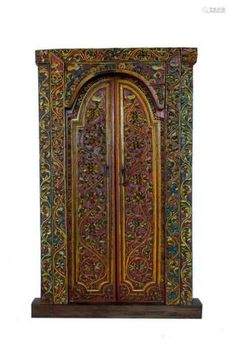 A BALINESE CARVED AND PAINTED WOOD DOOR Early 20th…