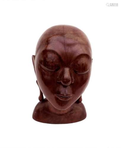 A BALINESE CARVED WOOD HEAD OF A GIRL mid 20th cen…