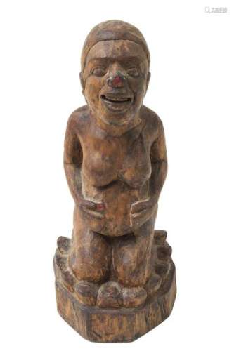 A BALINESE CARVED WOOD SCULPTURE OF A PREGNANT WOM…