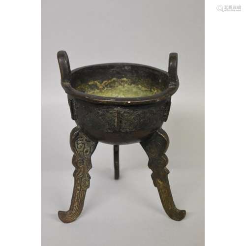 WITHDRAWN FROM SALE: A Chinese Archiastic bronze twin handled tripod ding,