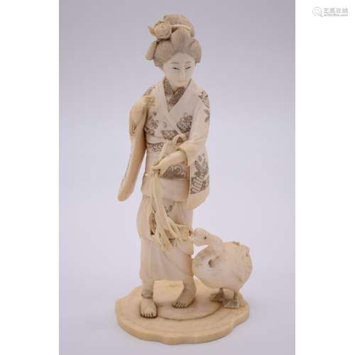 A good Japanese carved ivory okimono of a lady with a goose,