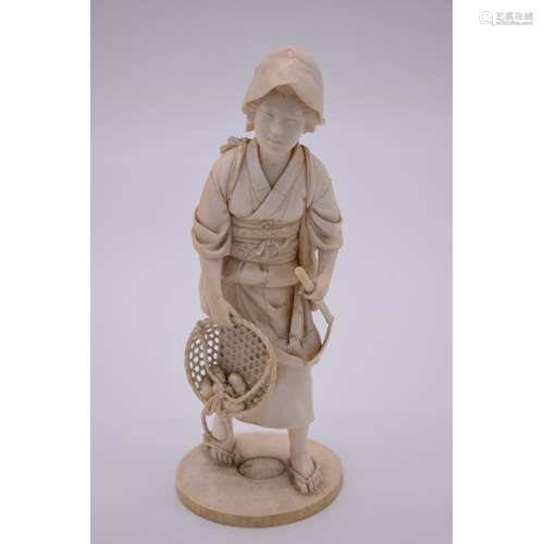 A Japanese carved ivory okimono of a lady gardener,