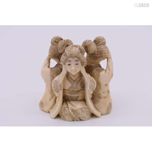 A Japanese carved ivory figure group of three geishas,