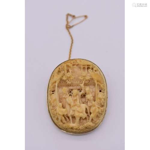 A Chinese carved ivory and 9ct gold mounted oval brooch,