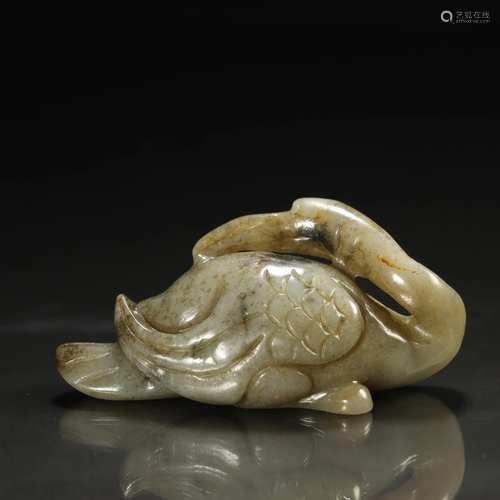 AN EARLY MOTTLED CELADON JADE BIRD FIG…