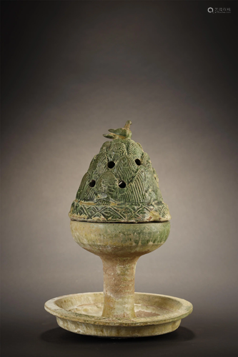 A GREENISH GLAZED BURNER, HAN D…