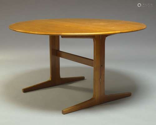 A circular teak dining table, c.1970, the top with one drop leaf raised on square legs to sledge