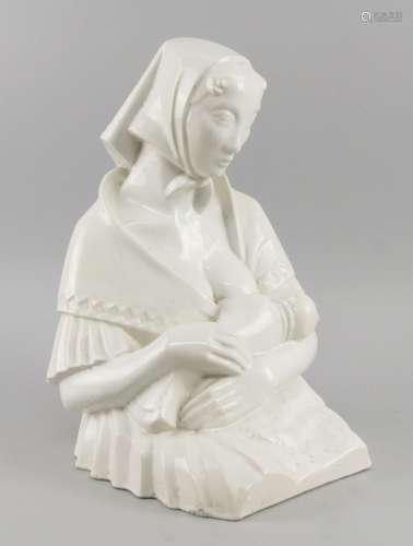 A Continental white glazed ceramic model of a young lady feeding her baby, early 20th century,