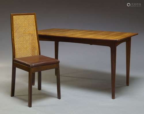 A teak extending dining table, c.1960, the curved rectangular top, with one pull out leaf beneath,