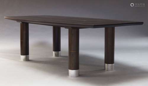 A large contemporary stained oak dining table, of recent manufacture, the shaped top, on cylindrical