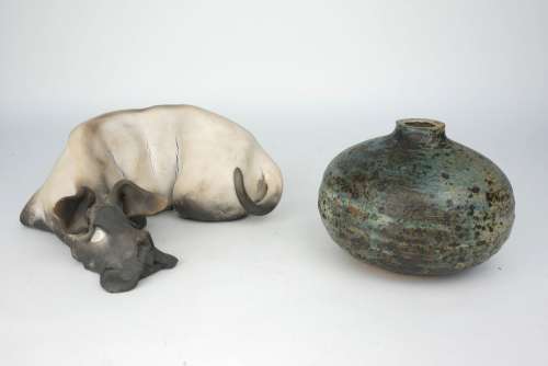 Ian Gregory, British, b.1942, a raku pottery reclining dog, monogram to underside, 21cm wide,