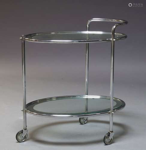 An Art Deco chrome and glass two tier trolley, c.1940, with two oval glass and mirrored tiers, on