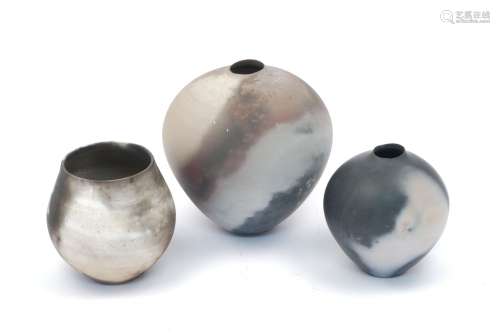 Three smoke fired burnished ceramic vases, of recent manufacture, one bearing seal for KM, two