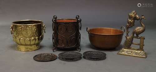 A brass repoussé work log bin, late 19th century, 30cm high, decorated with armorials above a