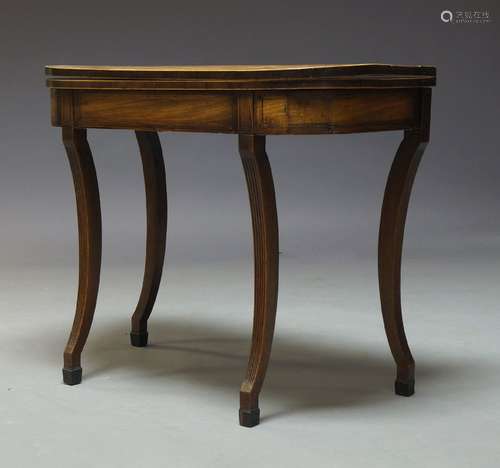 A Regency mahogany fold over tea table, on fluted sabre supports, 75cm high, 92cm wide, 46cm deep,