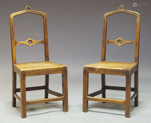 A pair of Gothic Revival oak side chairs, the arched backrest having central splat with pierced