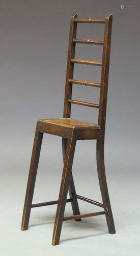 An unusual late Victorian mahogany child's deportment chair, with high spindle back, on square