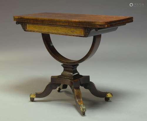 A Regency rosewood card table, the fold over top enclosing green baize lined playing surface, raised