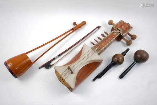 A bone decorated musical instrument, by JAS instruments, 66cm long, together with a coconut and