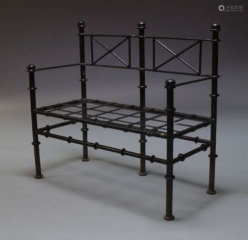 A black painted cast iron garden bench, late 19th, early 20th Century, with rod backrest and