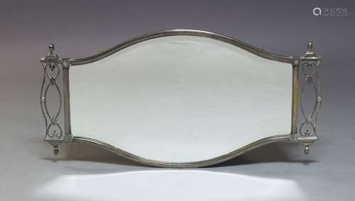 A silver plated wall mirror, first half 20th Century, the shaped frame, with beveled plate,