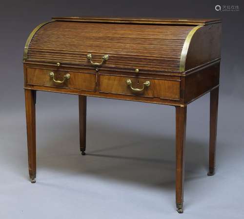 A George III mahogany roll top tambour desk, late 18th century, the tambour front enclosing an