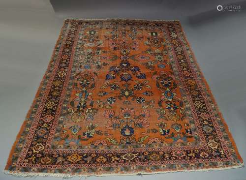 A Turkish carpet, early to mid 20th Century, the brick red field, boldly decorated with flowering