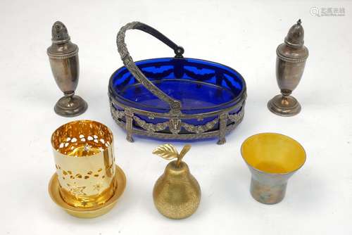 A blue glass-lined bonbon dish, the white metal mount with articulated handle decorated with swags