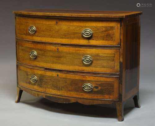 A George III mahogany and rosewood bow fronted chest of three long drawers, raised on splayed