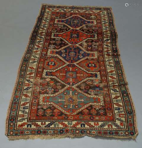 A Kazak rug, with five conjoined medallions, and ivory main border, 236cm x 113cm and two other rugs