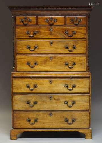 A George III mahogany chest on chest with dentil moulded cornice, above blind-fret carved frieze and