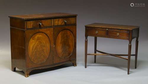 A George III mahogany cupboard, with two frieze drawers, above two circular paneled cupboard